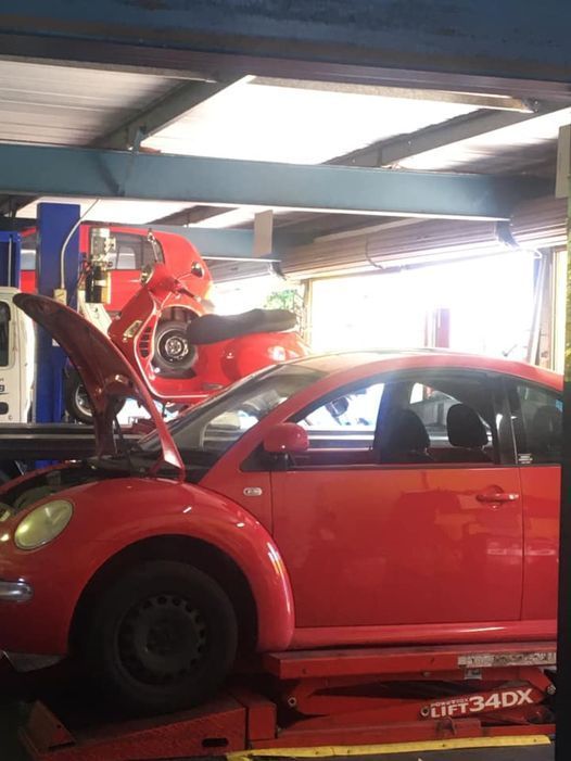Red Car is on a Lift With the Hood Open — Kirra Mechanical in Coolangatta, QLD