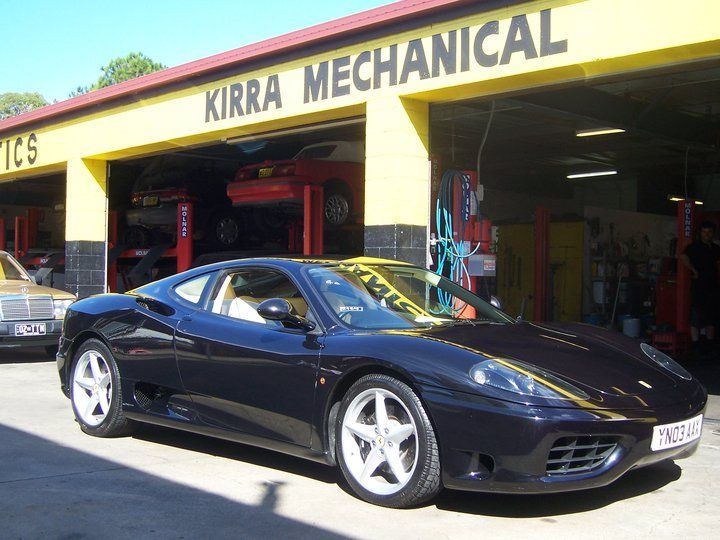 Black Sports Car is Parked in Front of a Building That Says Kirra Mechanical — Kirra Mechanical in Coolangatta, QLD