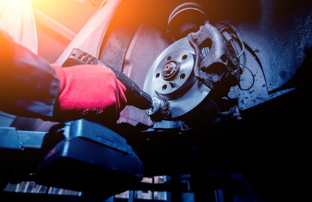 Person is Working on a Brake Disc on a Car — Kirra Mechanical in Coolangatta, QLD