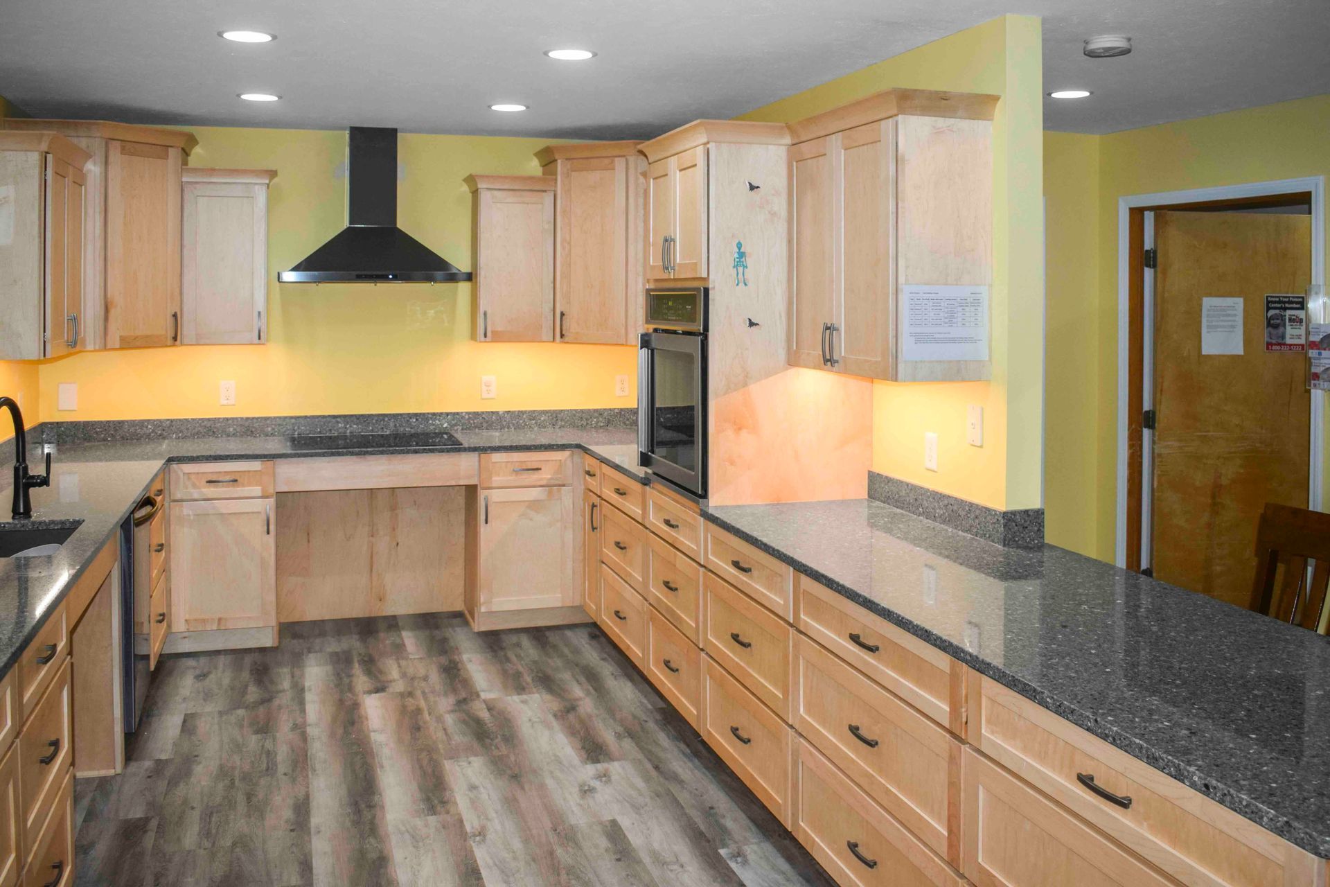 A kitchen with wooden cabinets and granite countertops.