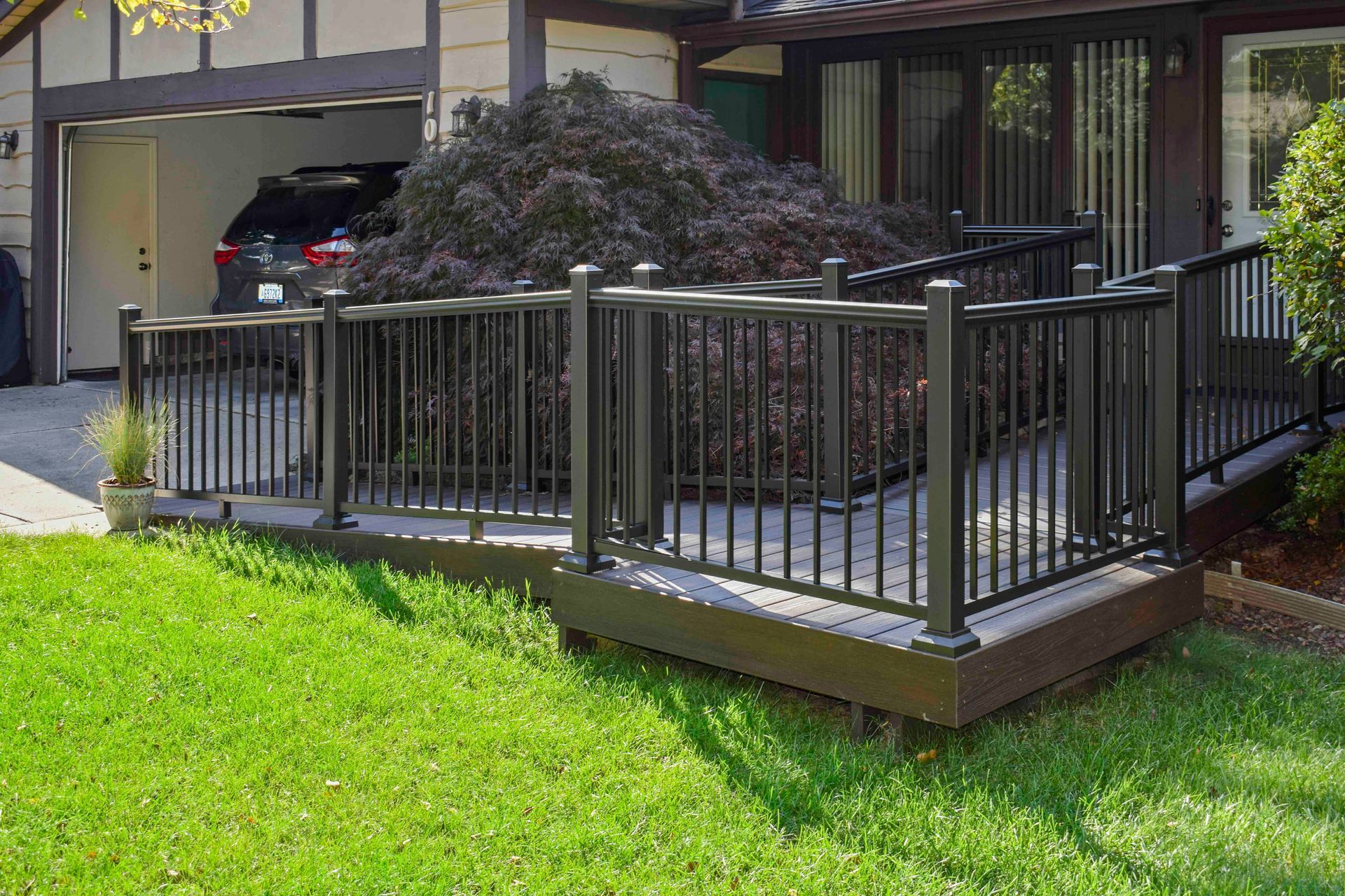 A house with a wheelchair ramp going from the driveway to the front door.
