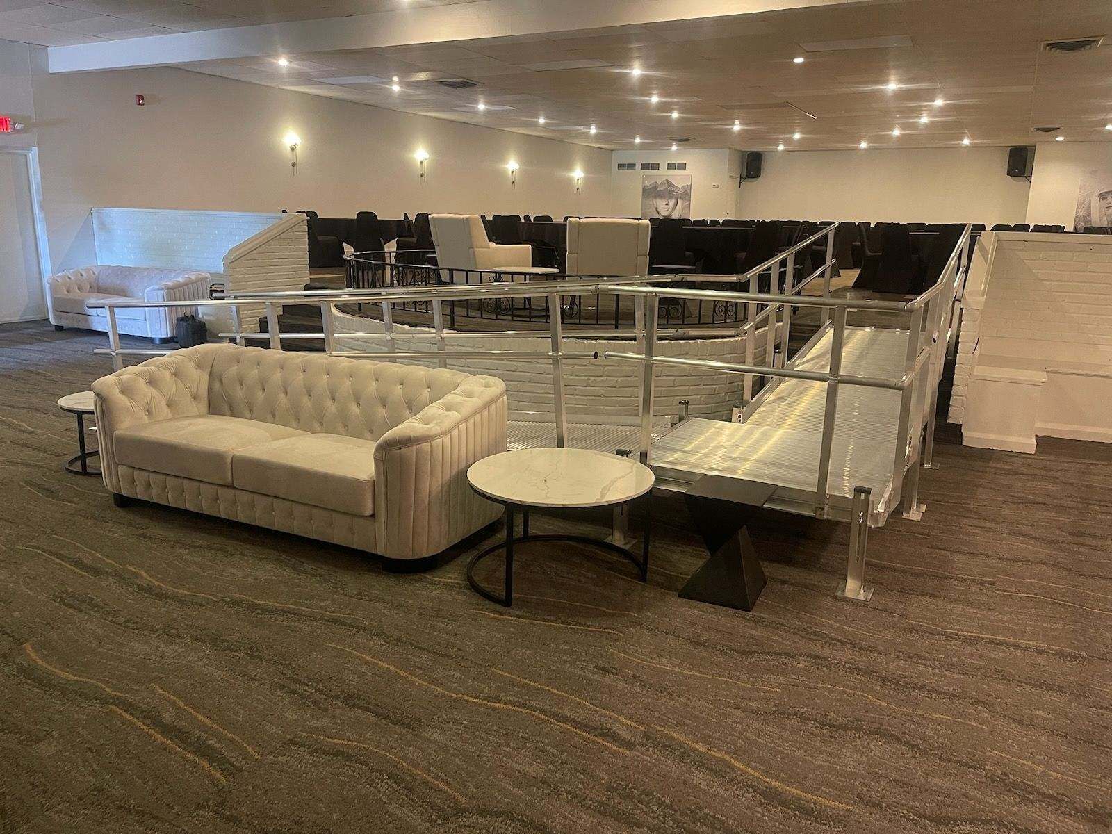 There is a couch and a table in the middle of the room.