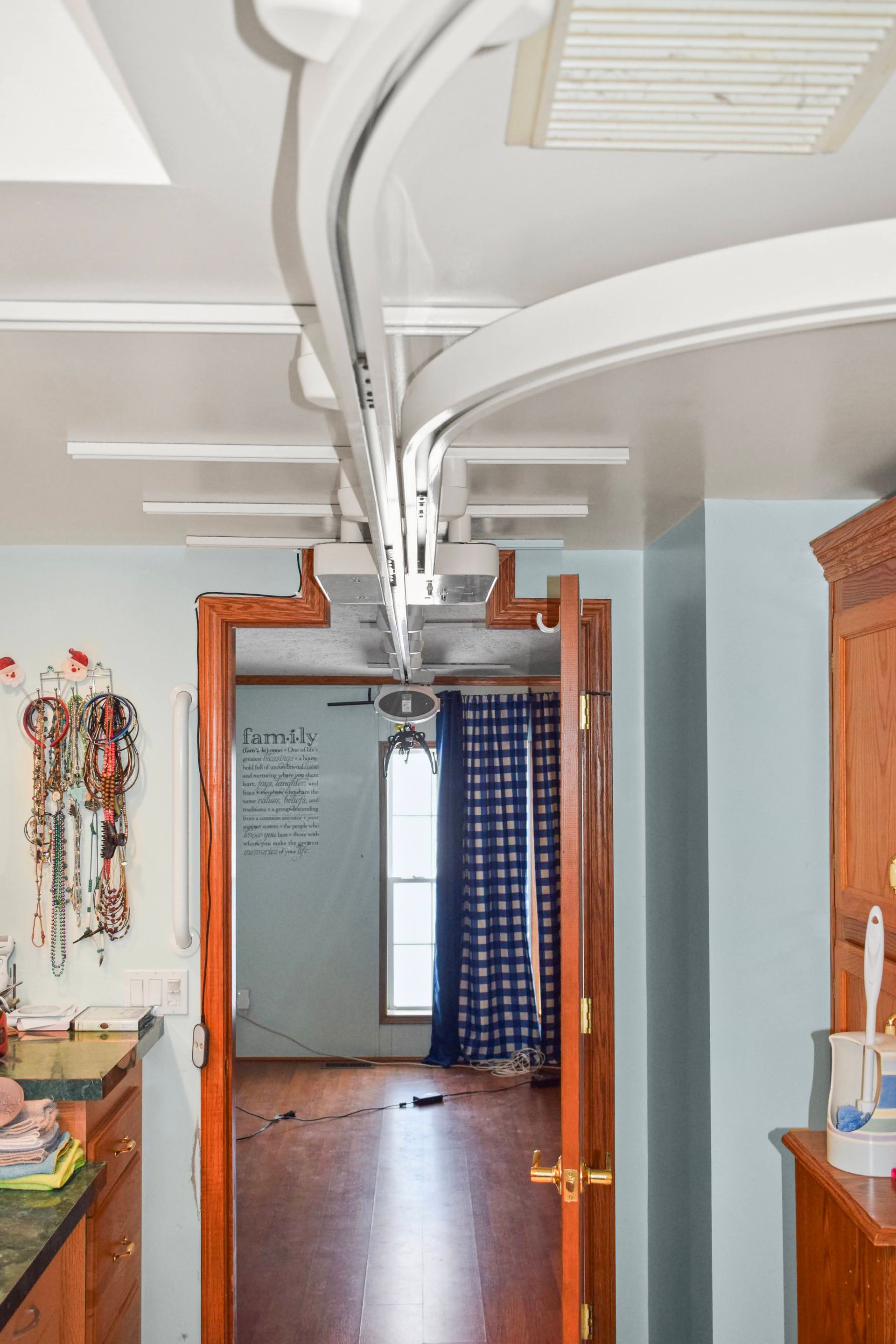 A room with a ceiling lift going through the doorway.
