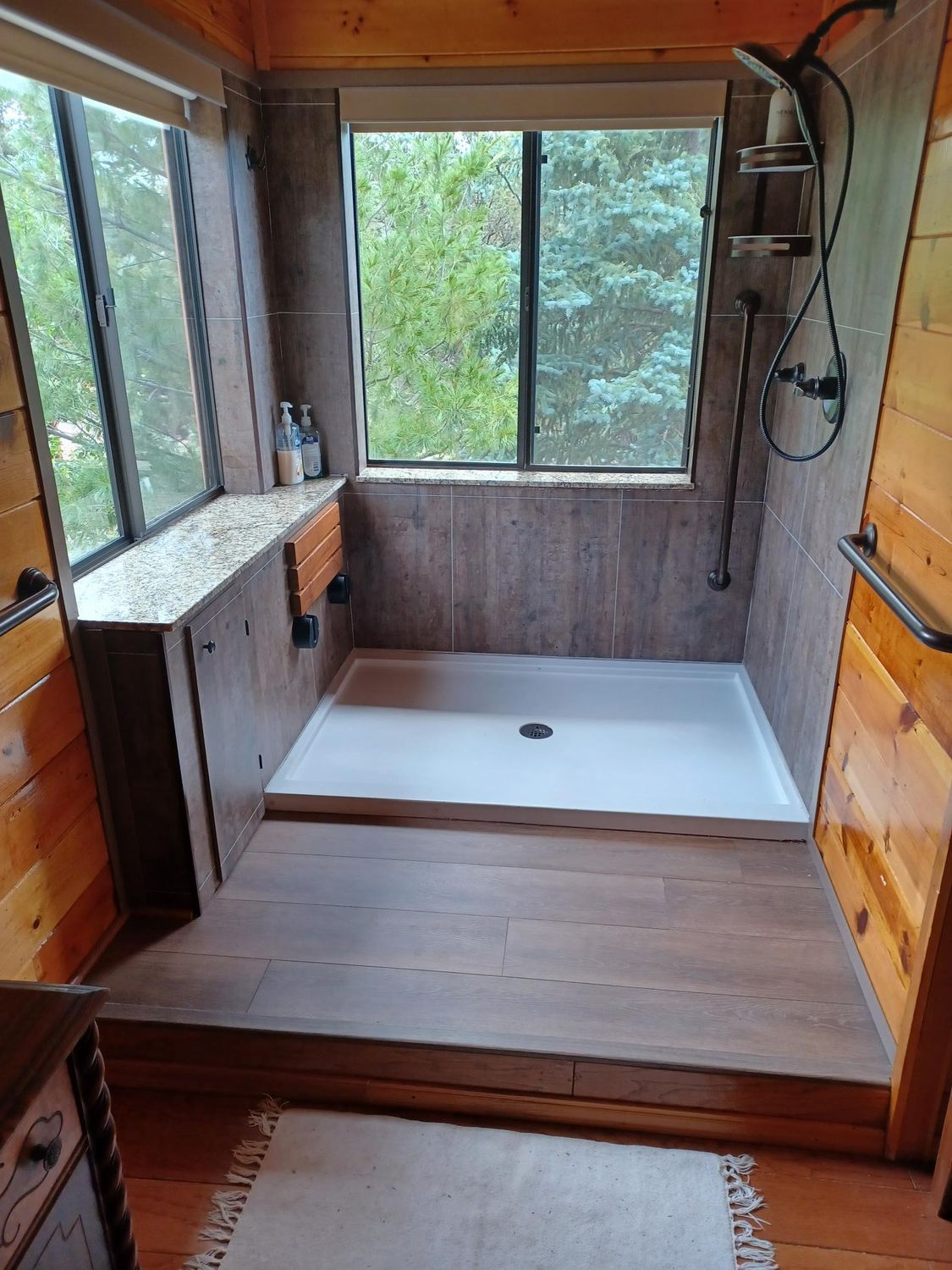 a bathroom with a walk in shower and a window.