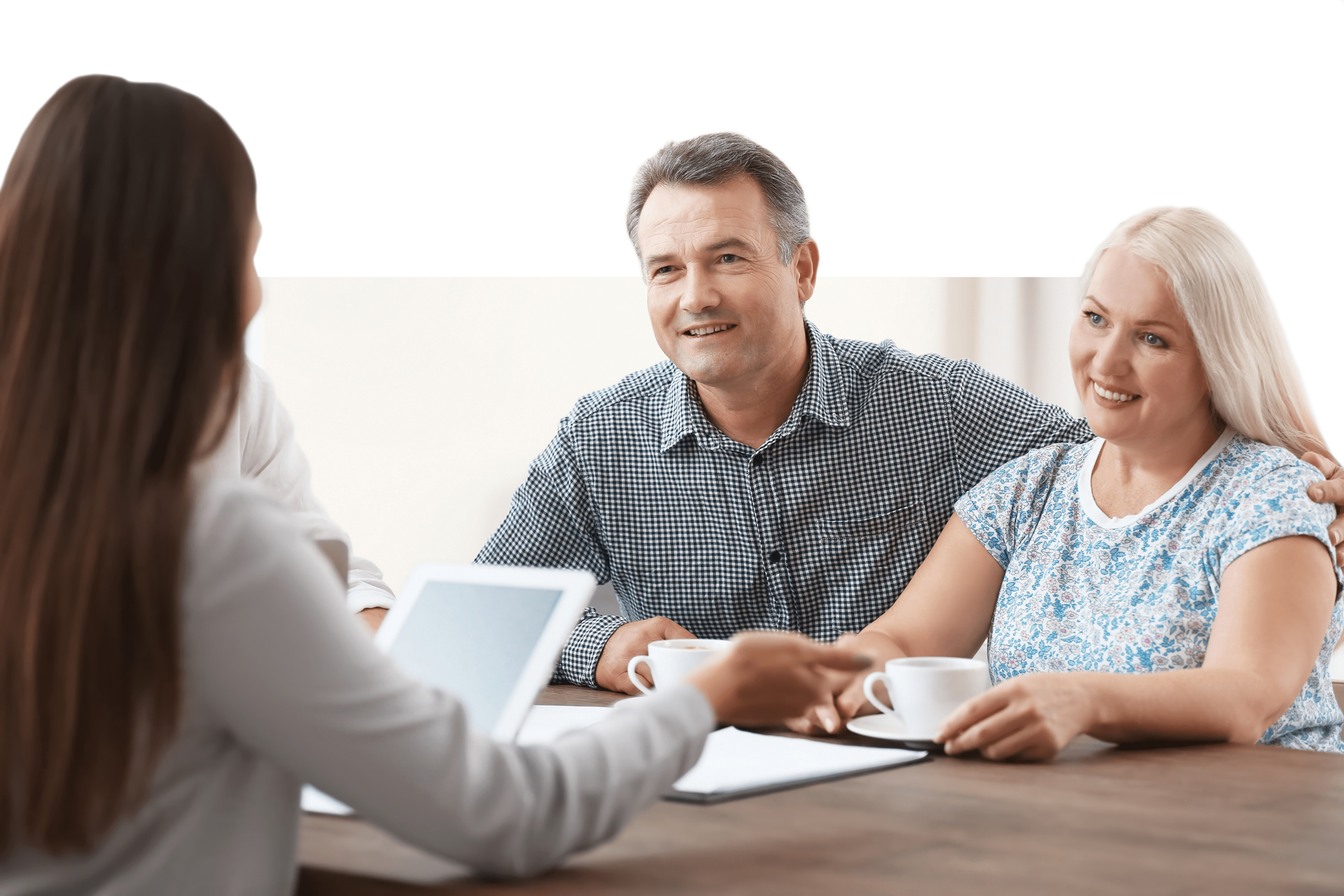 a woman is sitting at a table with a man and woman.