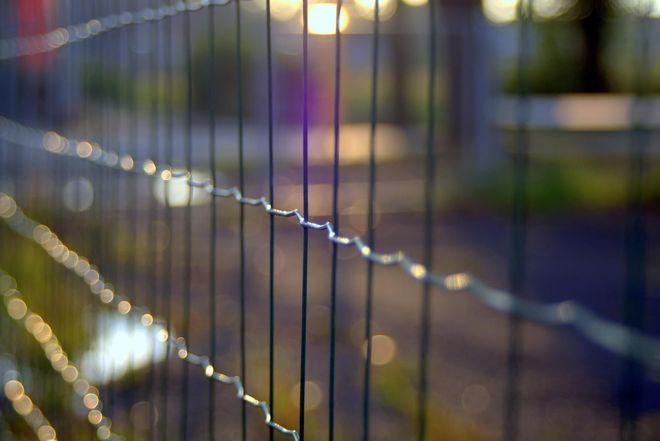 Fence contractor working on a residential fence in San Angelo