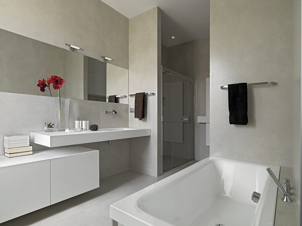 A Bathroom with a Bathtub a Sink and a Mirror — Darryl Tickle Building Pty Ltd in Alice River, QLD