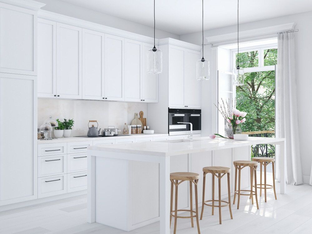 A Modern White Kitchen with A Wooden Bar Stools — Darryl Tickle Building Pty Ltd In Alice River, QLD