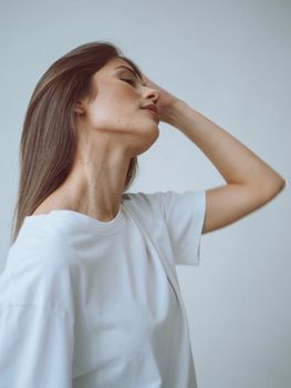 Side profile of a woman's jawline and neck in soft natural light