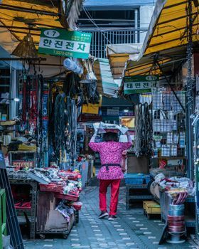 Woman carrying shopping bags on a city street in Seoul during the day