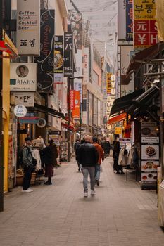 Woman walking along a busy shopping street