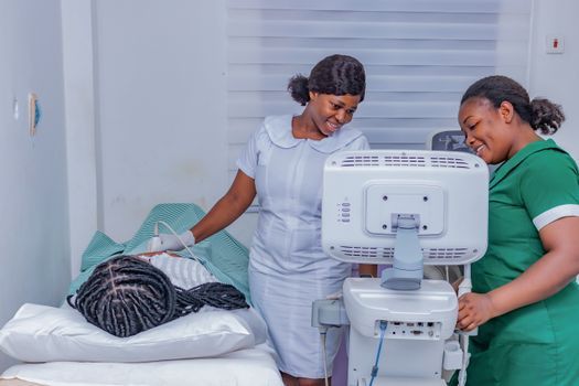 Doctor holding an ultrasound lifting handpiece beside a patient on a treatment bed