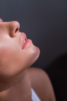 Profile of a woman with a defined jawline near a window