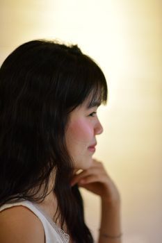 Side profile of a woman's temple and cheek in soft natural light