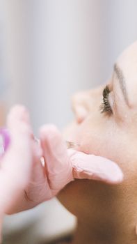 Close-up of skin booster micro-injections being given on a woman's cheek