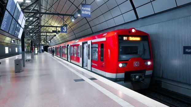An airport express train arriving at a modern station platform