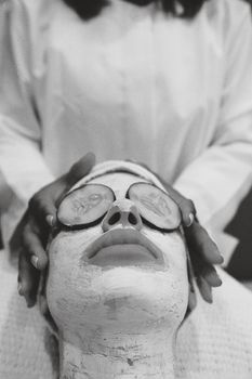 Woman relaxing on a treatment bed before a facial skin-tightening session
