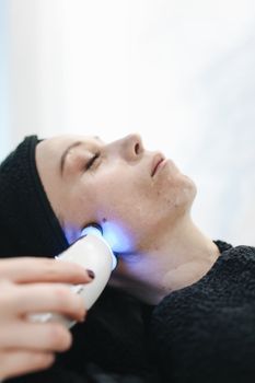 Gentle ultrasound facial treatment being performed on a woman’s cheek