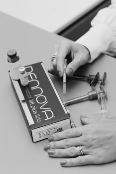 Doctor preparing a small syringe for a cosmetic injection