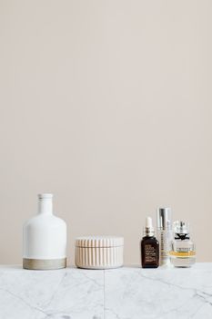 Minimalist skincare bottles arranged on a marble shelf in soft morning light