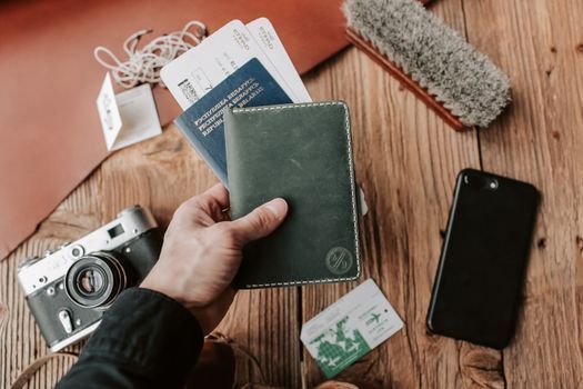 A passport and boarding pass on a table next to a phone and coffee