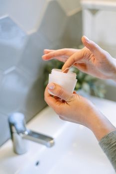 Woman with freshly cleansed skin getting ready for an appointment