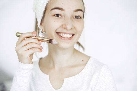 Smiling woman with fresh, glowing skin in a bright room