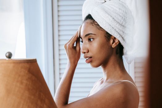 Woman gently touching her forehead and brow area