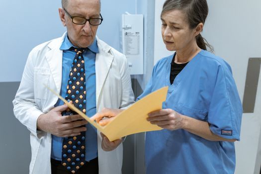 Doctor reviewing medical history with a woman before treatment