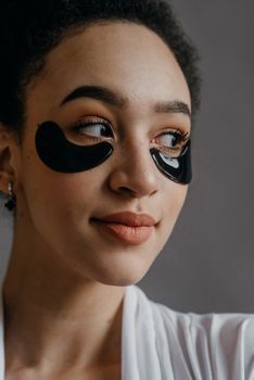 Close-up of the under-eye area of a young woman in natural light