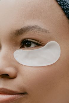 Close-up of a woman's under-eye area during a gentle skin treatment