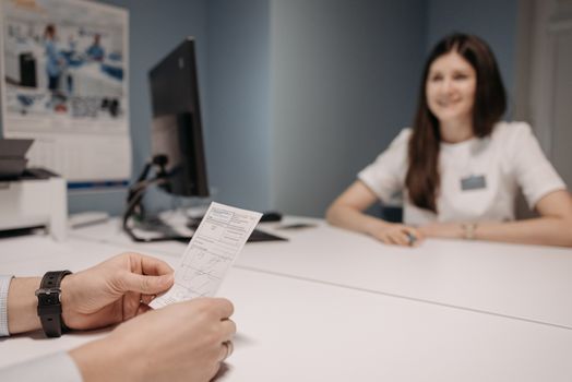 Doctor explaining a treatment plan to a patient at a consultation desk