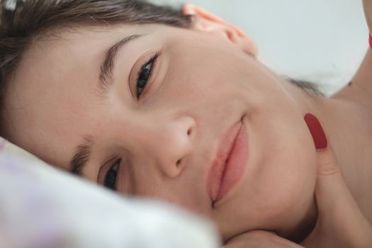 Close-up of a smiling woman’s cheeks and mouth area in soft daylight