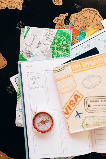 Passport, notebook and calendar laid out for planning a trip