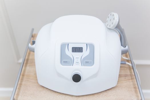 A skin booster injector device being used on a cheek in a modern clinic