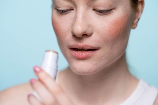 Close-up of natural-looking lips with clear lip balm in soft light