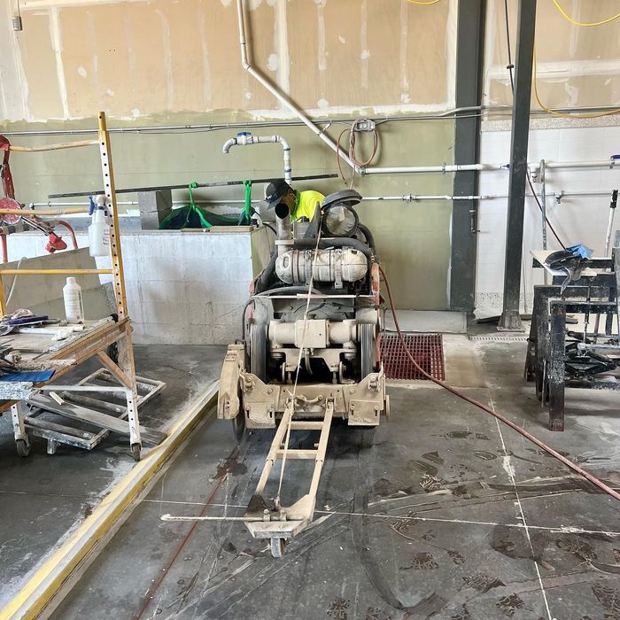 Construction site with a cement mixer and tools inside a partially finished garage