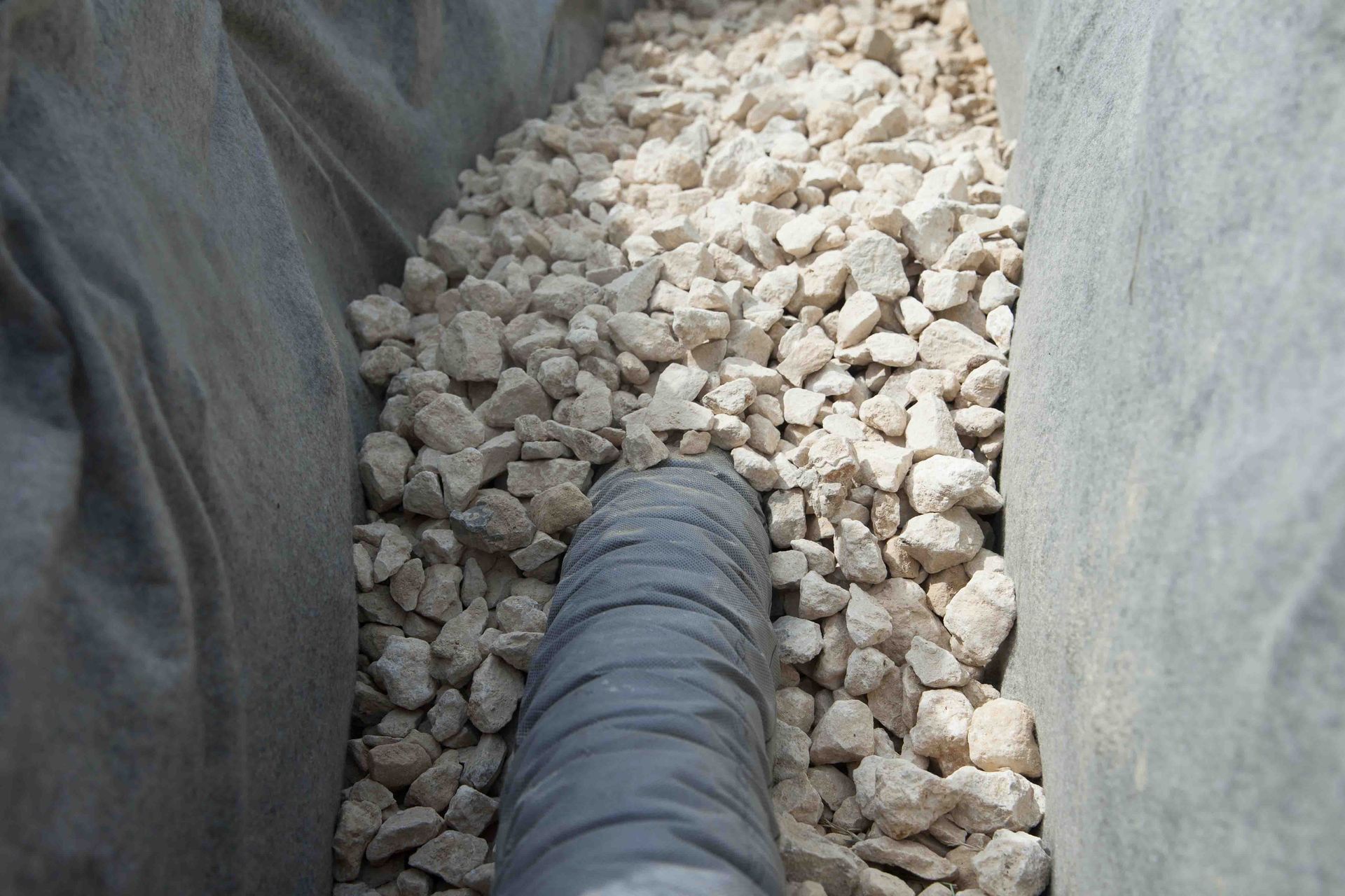 A person is mixing cement in a concrete mixer