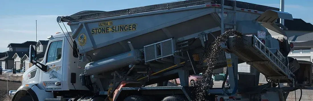 A person is mixing cement in a concrete mixer