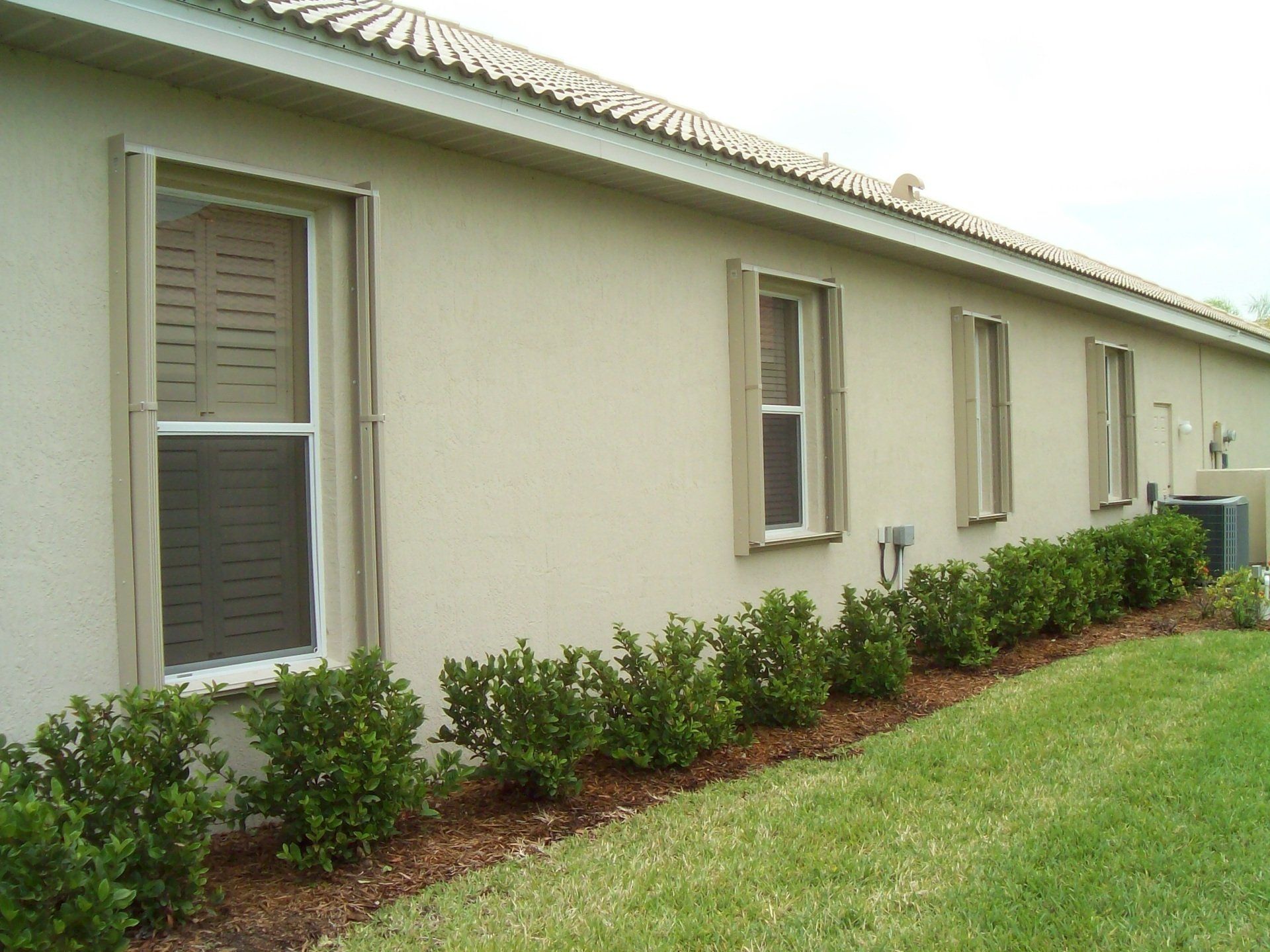 Plants Beside A House — Reliable Shutter Co., Inc. — Venice, Florida