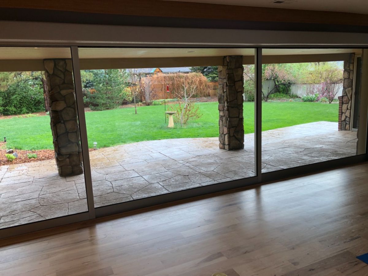 a living room with sliding glass doors leading to a patio .