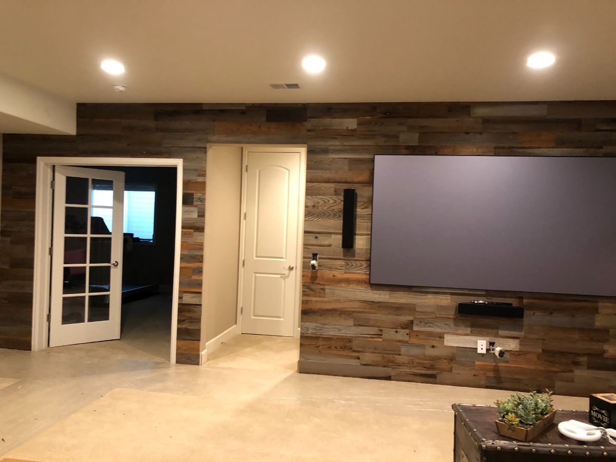 a living room with a wooden wall and a flat screen tv