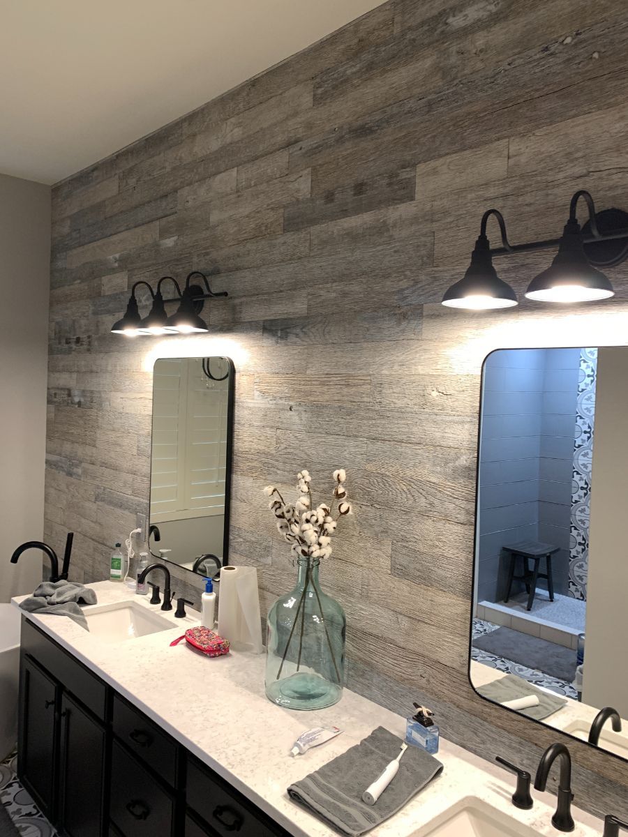 a bathroom with two sinks and two mirrors .