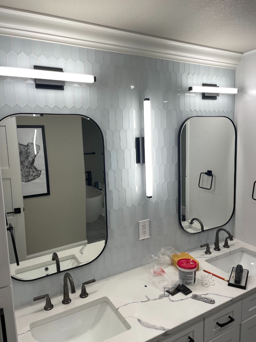 a bathroom with two sinks and two mirrors .