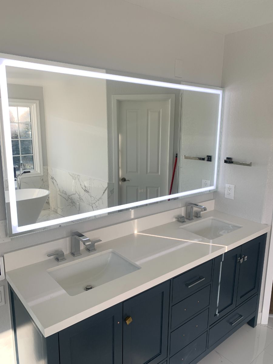 a bathroom with two sinks and a large mirror .