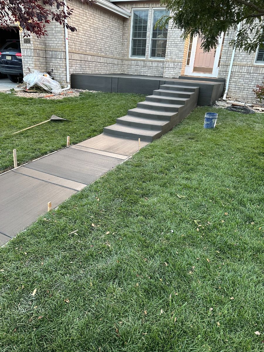 there are stairs leading up to the front of a house .