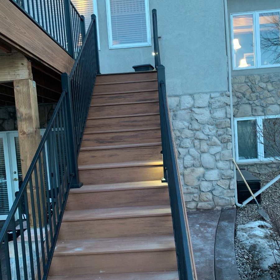 a set of wooden stairs leading up to a stone building