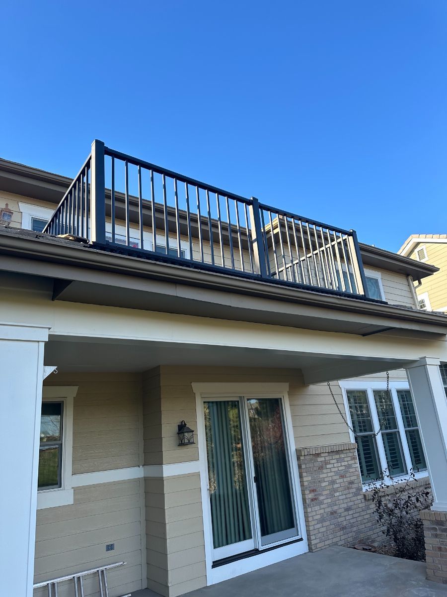 a house with a balcony on the top of it .