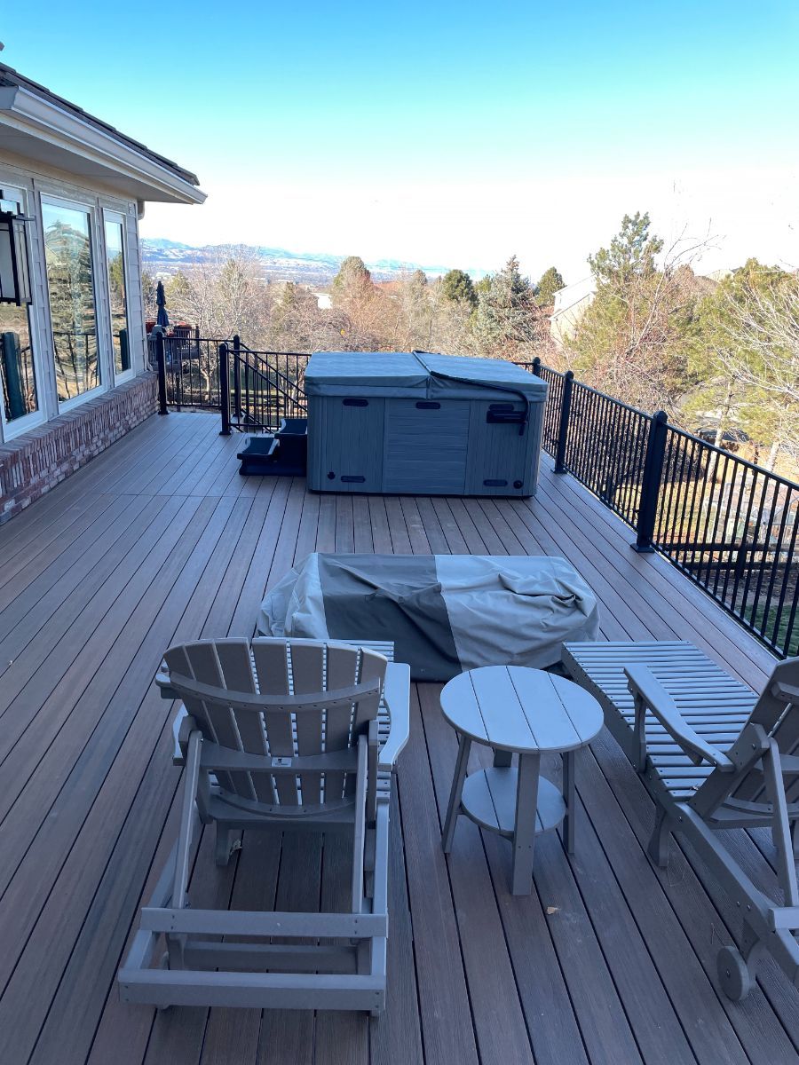 there is a hot tub on the deck of a house .