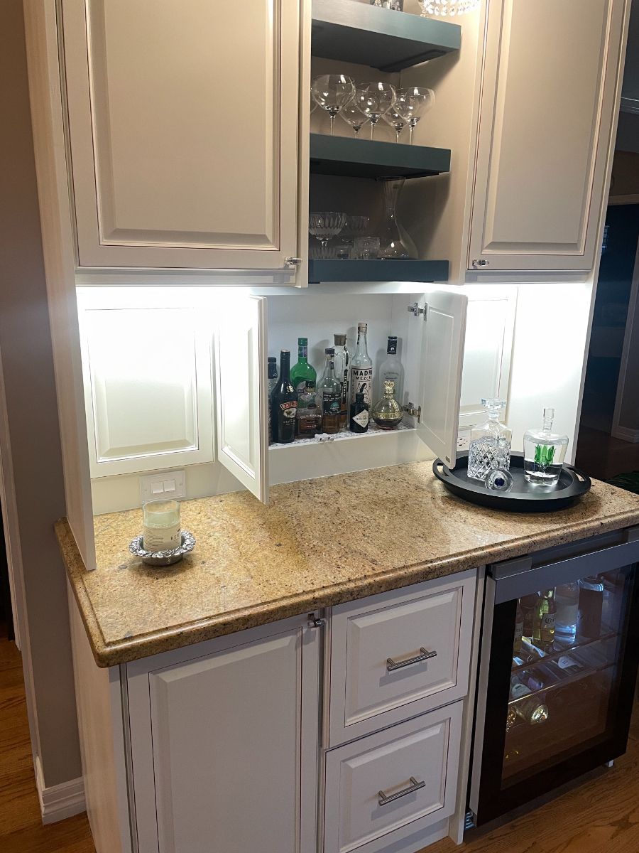 a kitchen with a bar and a refrigerator .